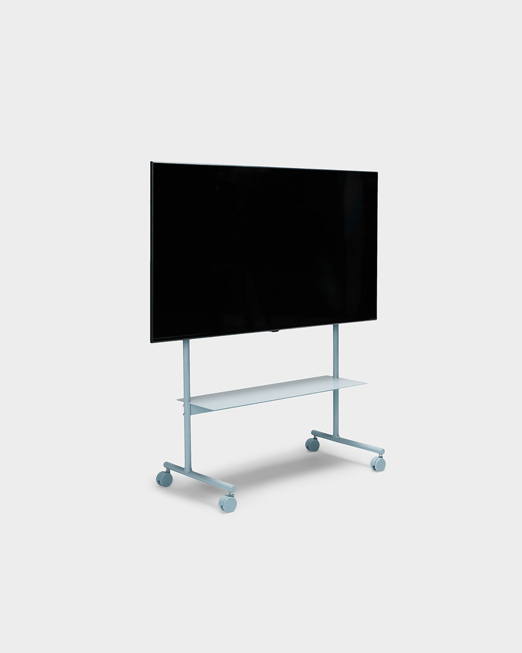 Rover TV stand in Powder Blue shown at an angle in studio, mounted flat-screen TV, lower shelf and locking wheels